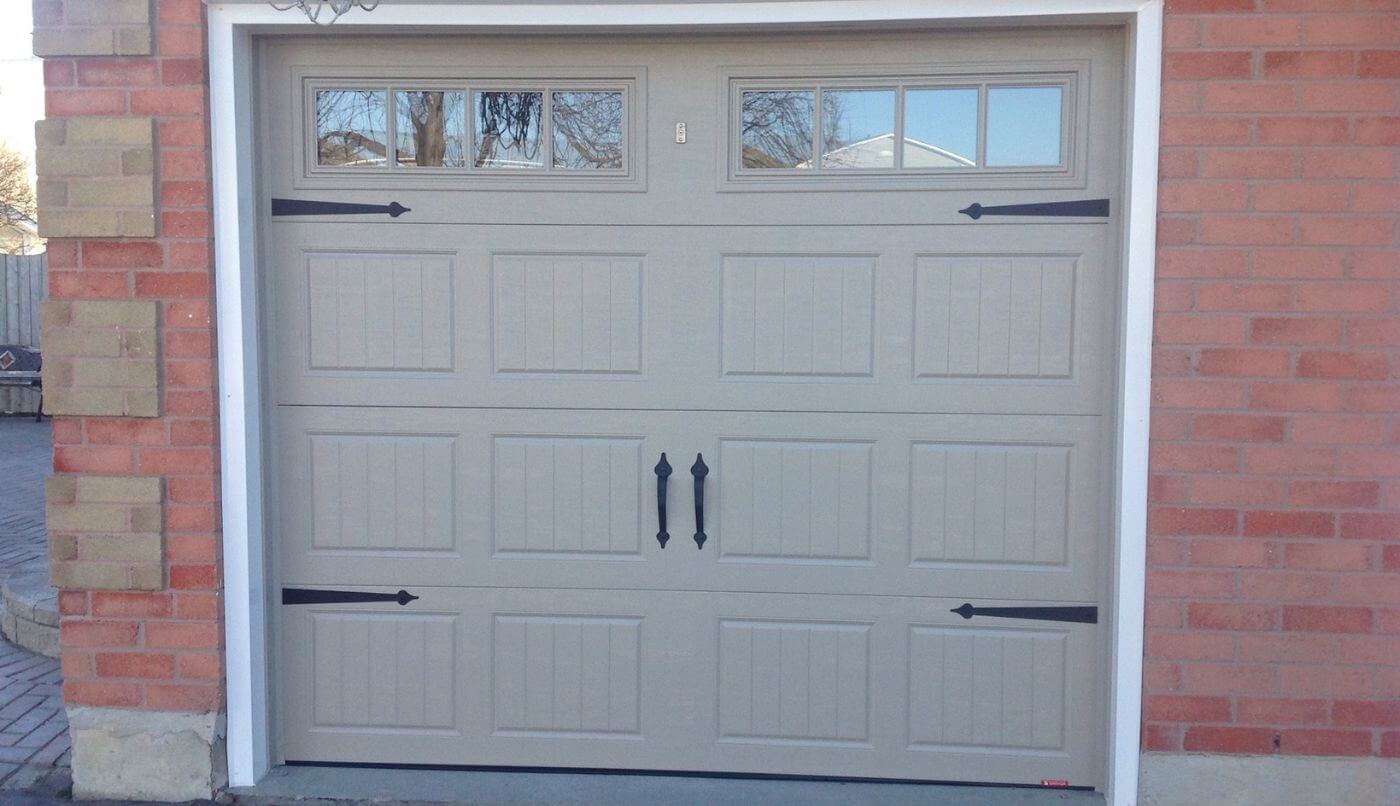 A garage door equipped with two windows, highlighting a practical design for residential spaces.